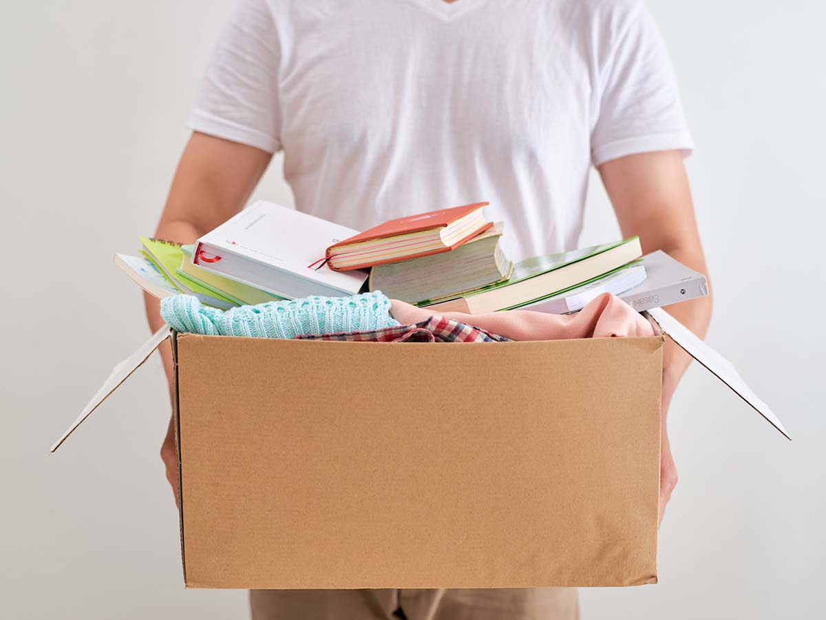 A man carrying a box full of items