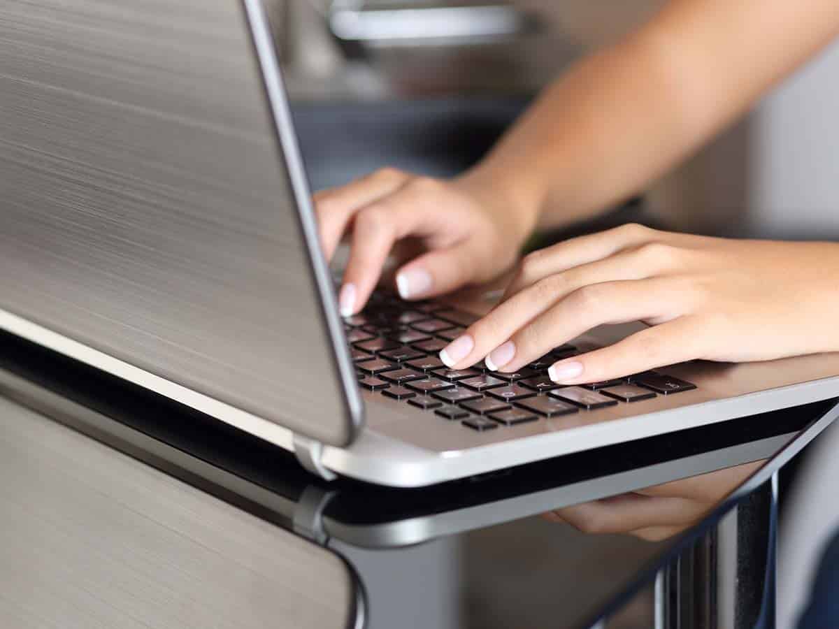 1200x900GMB-2 Person typing on a laptop