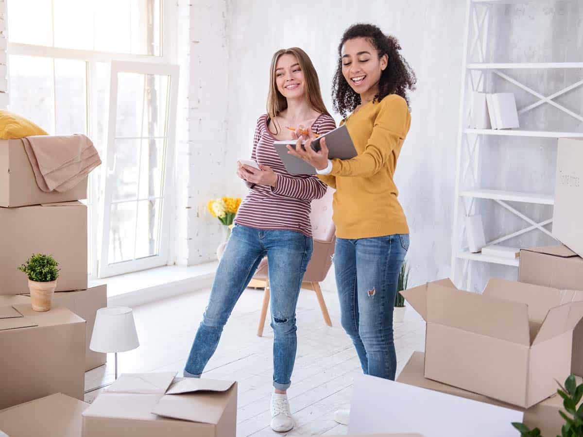 Two people with a lot of packing boxes