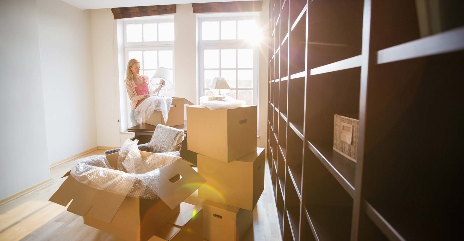 A woman packing up boxes for a move
