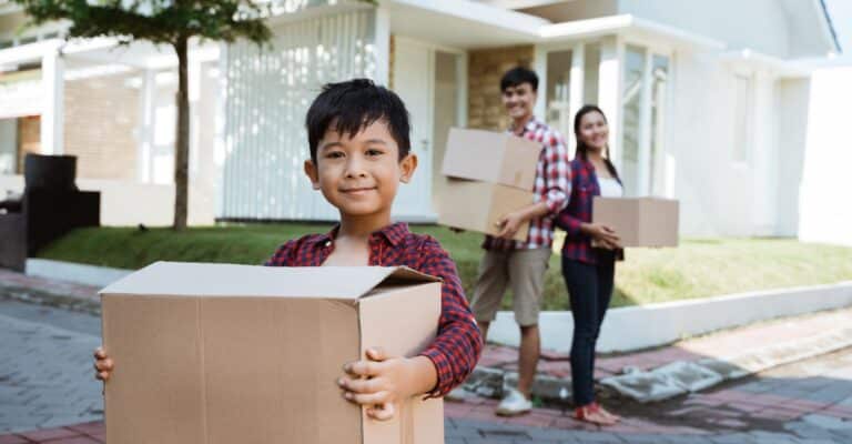 Little boy helping his parents on moving day
