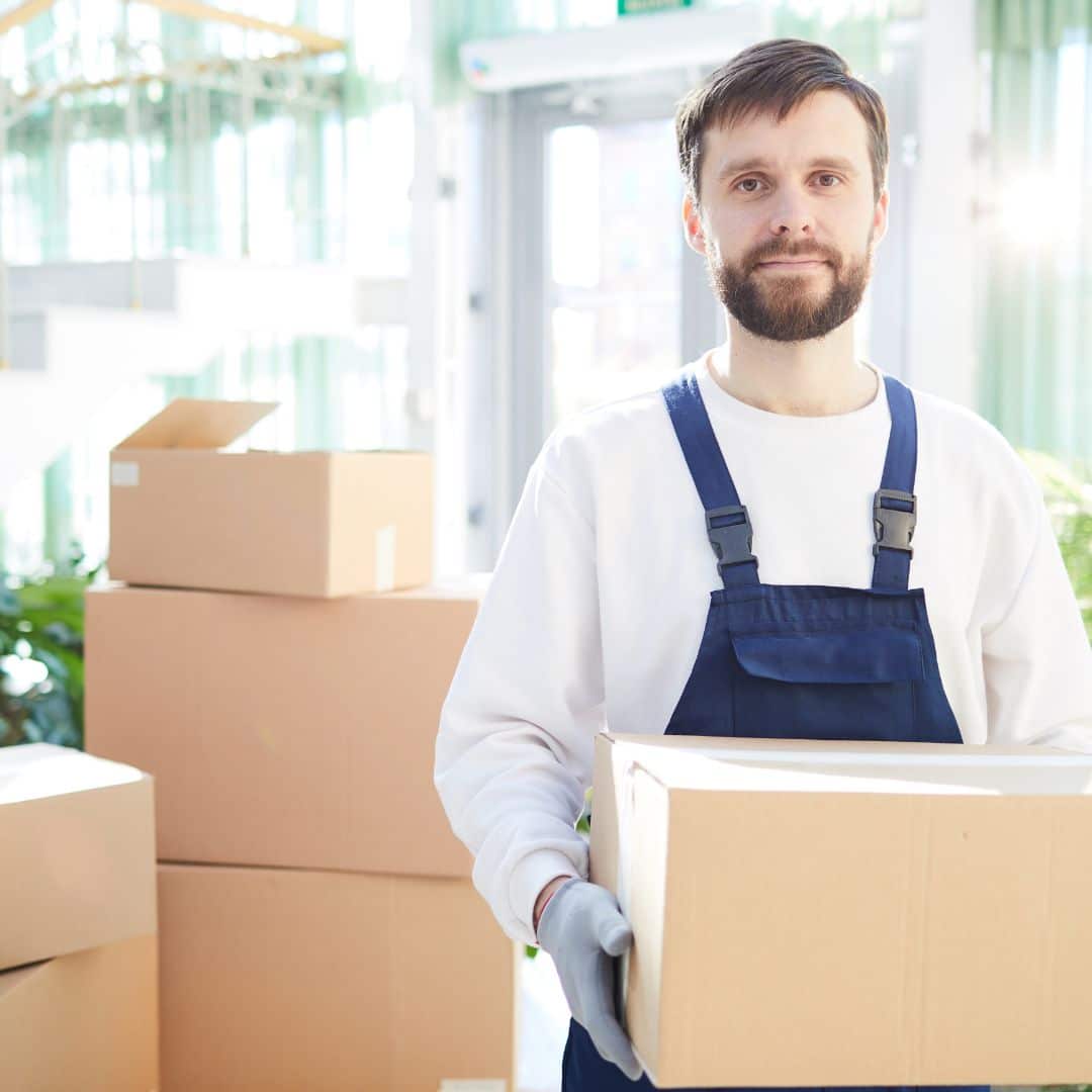 A mover holding a moving box.