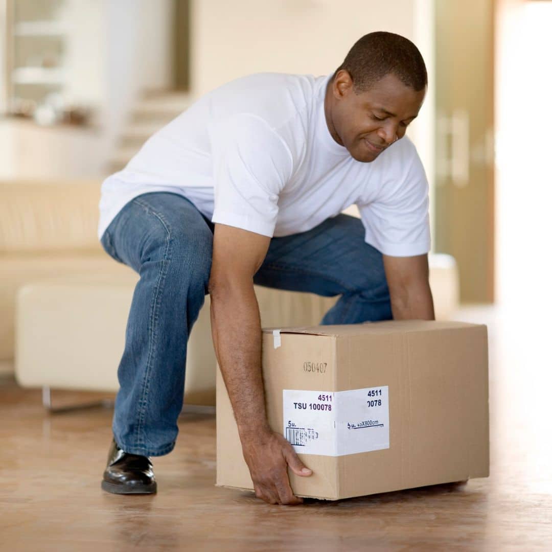 man lifting a heavy box off the floor