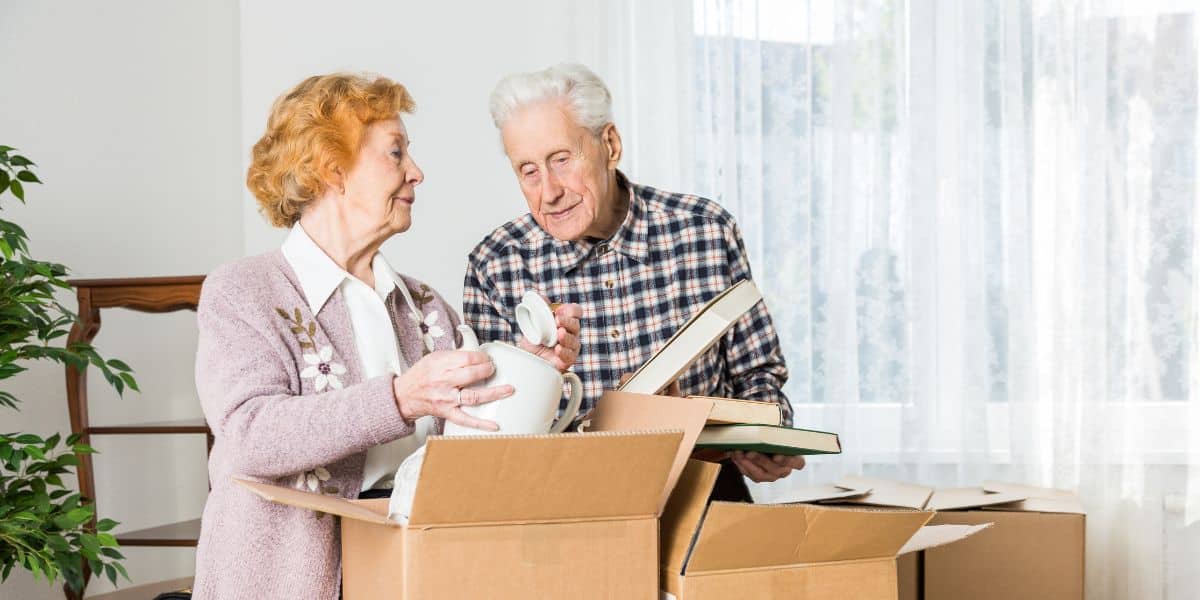 A senior couple packing boxes together, preparing to move to a new home.