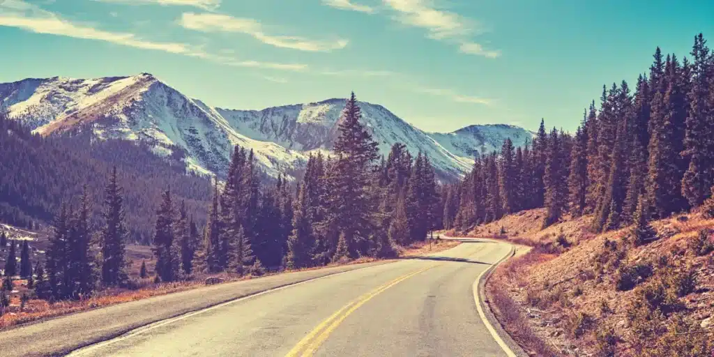 Scenic Colorado mountain highway representing reliable moving routes served by Denver furniture movers