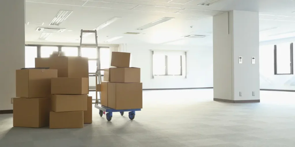 Professional commercial moving boxes and equipment in Denver office space during business relocation by licensed moving company
