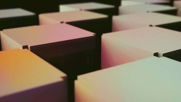 Stacked moving boxes in an office environment, symbolizing relocation.