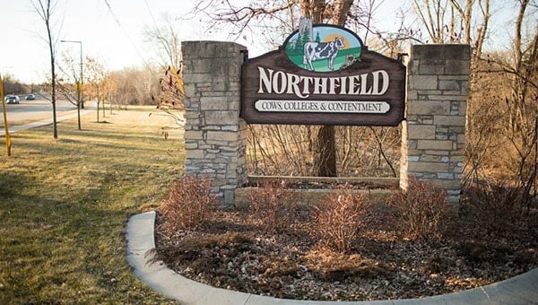 Northfield community entrance sign with stone pillars and logo.