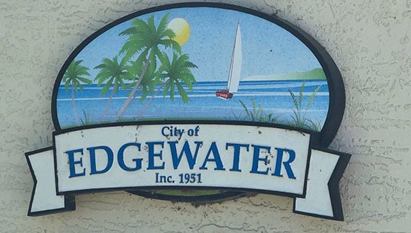 Edgewater city sign with palm trees and sailboat on water, welcoming visitors.