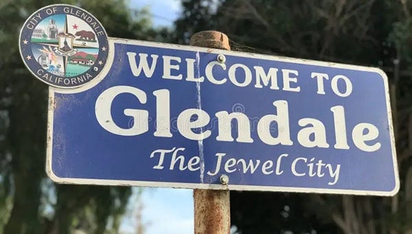 Glendale welcome sign in California with city emblem.