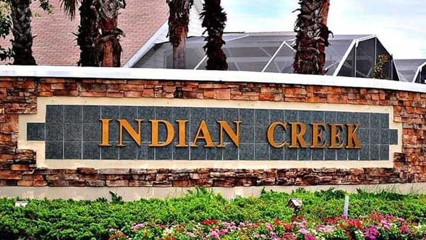 Indian Creek neighborhood entrance sign with brick and stone design.