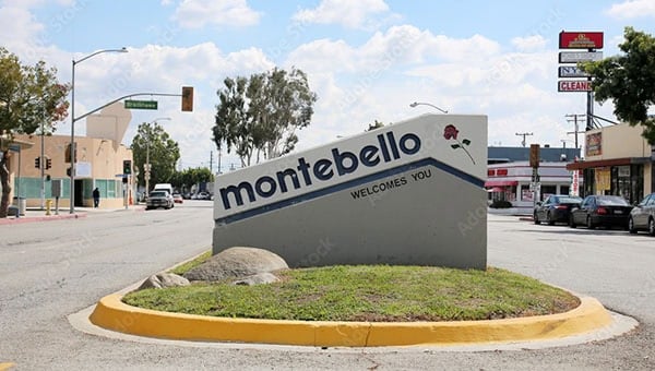 Abe Lincoln Movers logo on Montebello welcome sign in a busy city intersection.