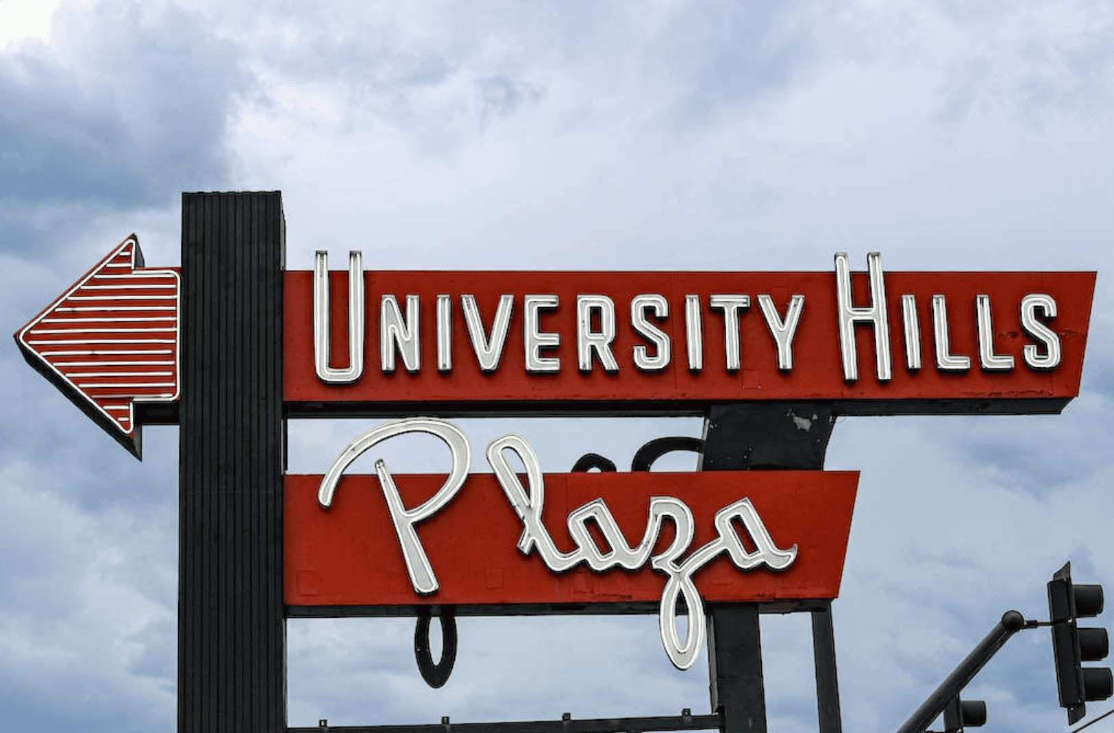 Sign for University Hills Plaza featuring Abe Lincoln Movers, a professional moving company.