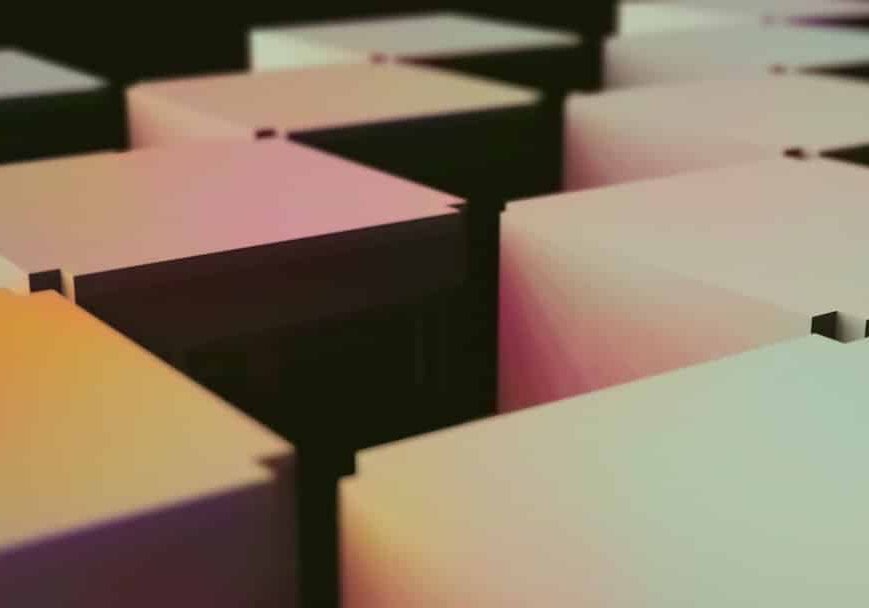 Stacked moving boxes in an office environment, symbolizing relocation.